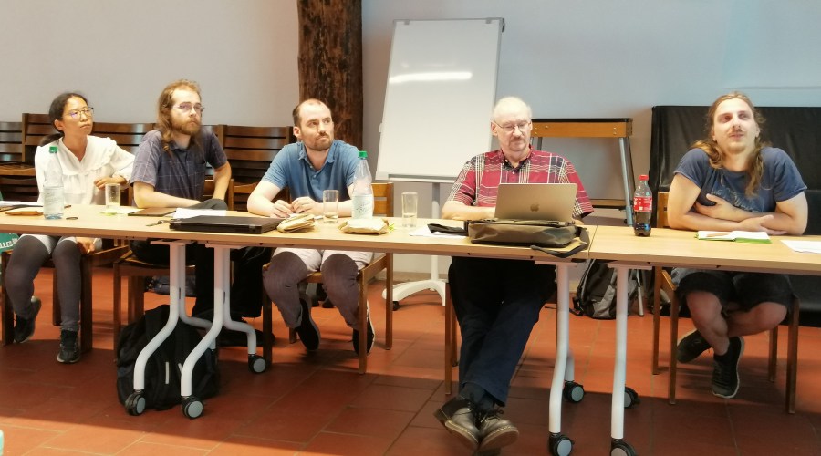Prof. Ueli Grossniklaus taking notes on his laptop among ICIPS PhD students and postdoc